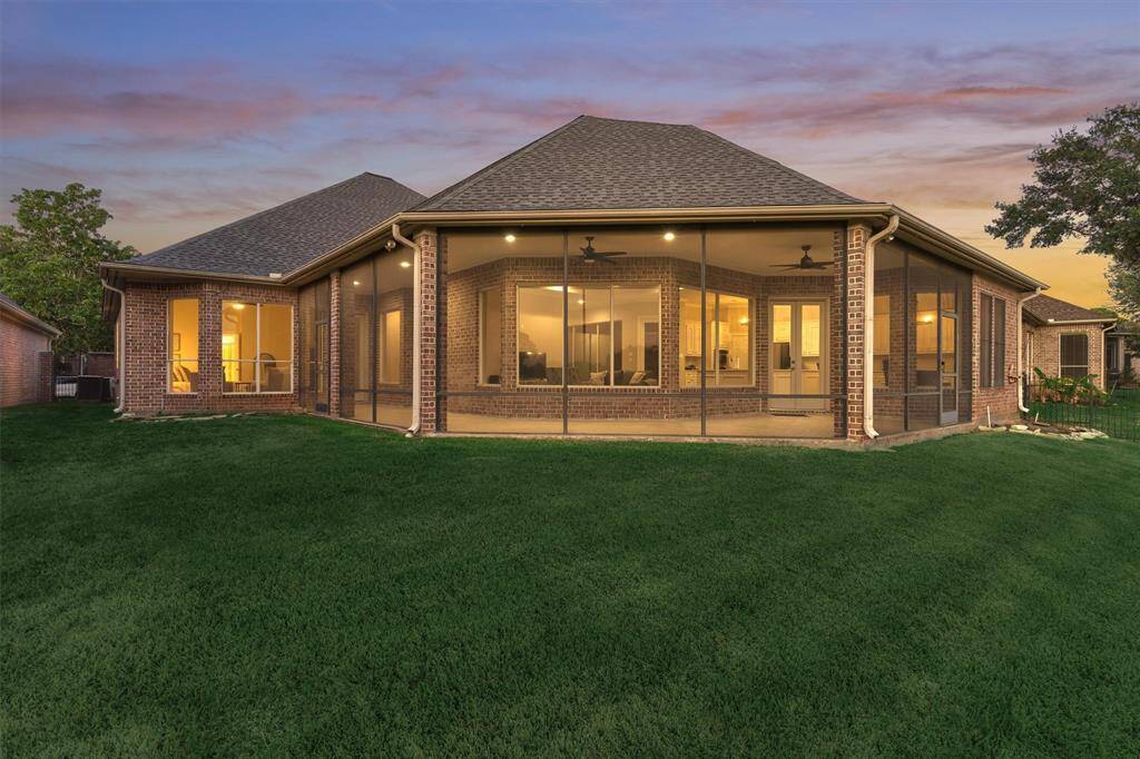 This back elevation photo of your new home shows the screened back patio allowing year long enjoyment.