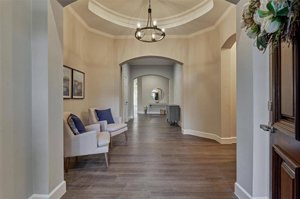 The recessed ceiling creates a air of drama in the foyer. To your right is a hallway that leads to two bedrooms and a Jack and Jill bath.