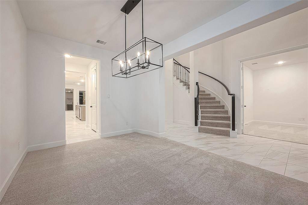 An upstairs balcony overlooks the family room and foyer, adding to the open and airy feel of the home.