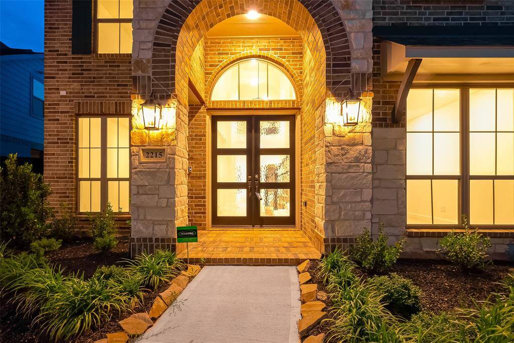 A three-car garage with tandem parking and auto garage remote. A sprinkler system ensures easy maintenance of the lush landscaping.