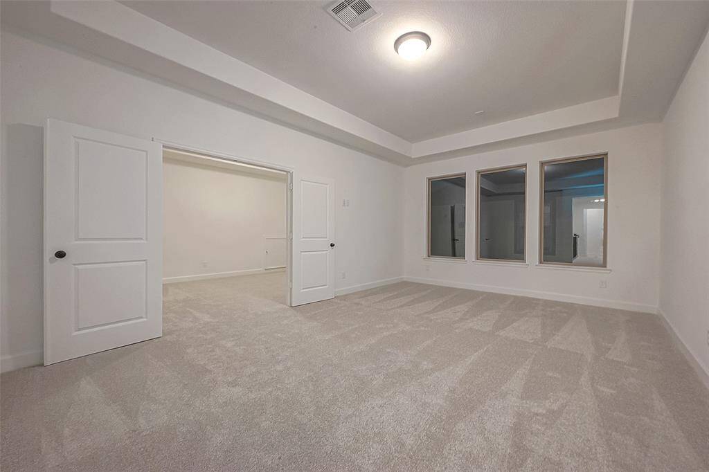 Media room with a coffered ceiling and wired for sound.