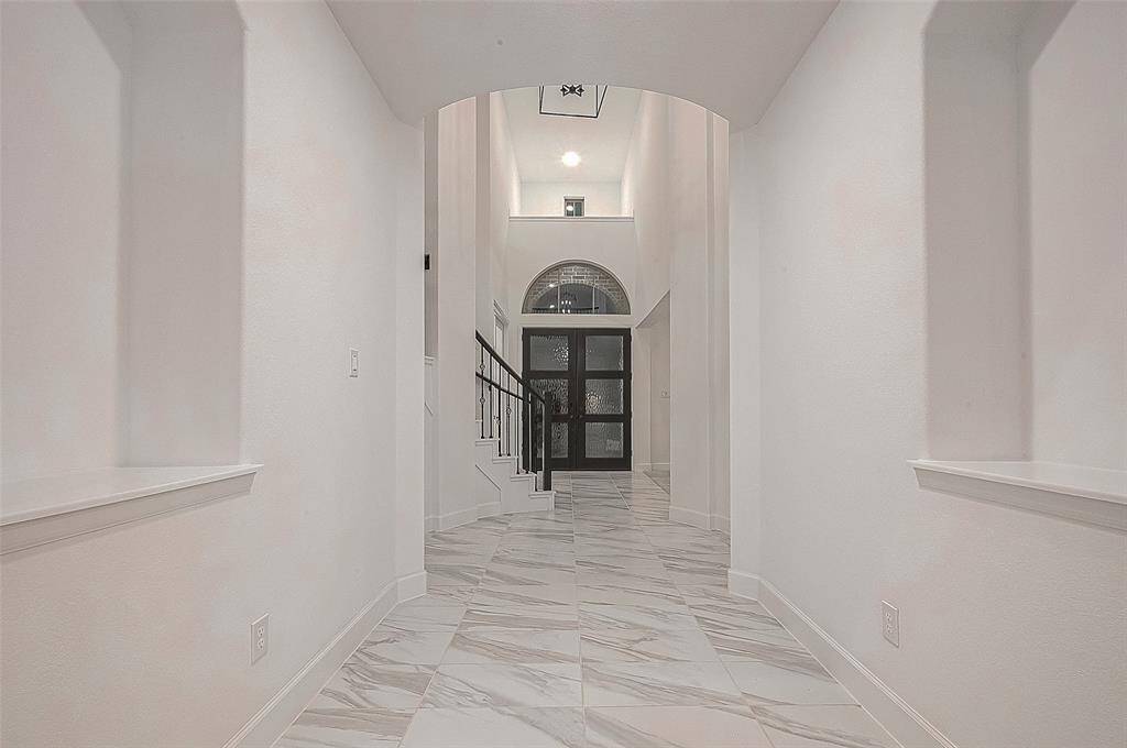 Home office, featuring elegant glass double doors, offers a quiet retreat for work or study.
