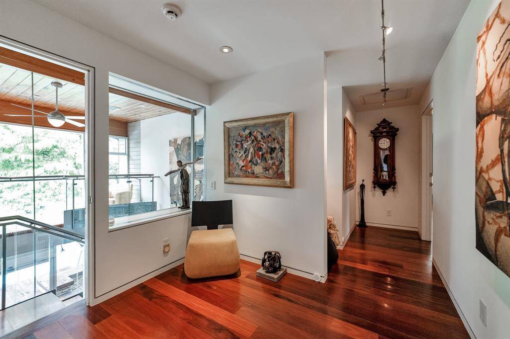 Upon entering the second floor hallway, this direction leads you to the primary suite. The natural light from the floor to ceiling windows fills the space nicely.