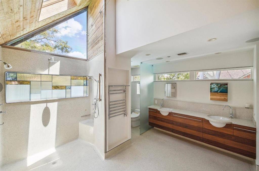 Seamless terrazzo floors and natural light fill this space, providing a relaxing escape.