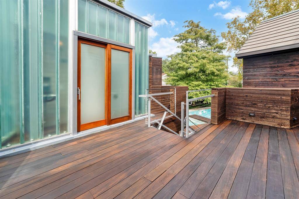 Upstairs deck off the media room/ dance deck that leads to the bathroom tower. Stairs lead you to the pool area below and there is a separate entry to the back yard.