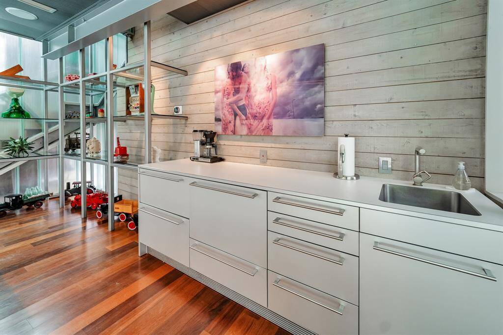 The first floor of the guest house is currently being used as a pool room with a pool table and a kitchenette. Pull out refrigerator drawers, included.