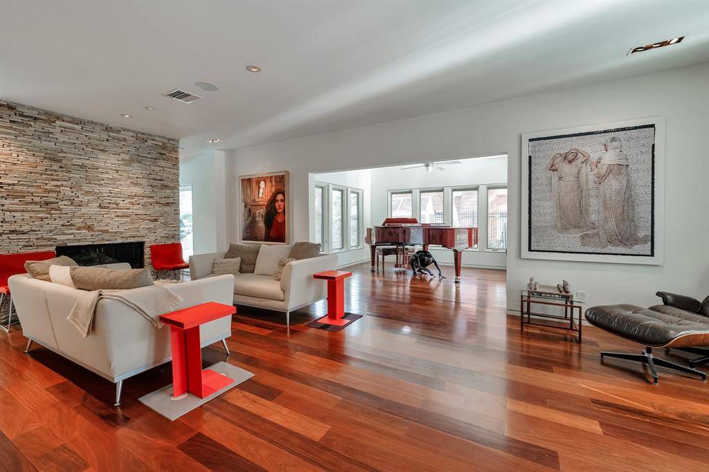 Capture the essence of comfort and sophistication in the formal living. The Brazilian chestnut floors are a beautiful addition that complement the contemporary charm of the gas fireplace.