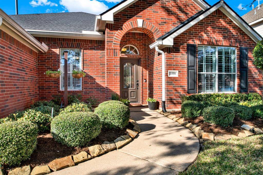 Great curb appeal with the stone-bordered path, arched entryways and large windows.