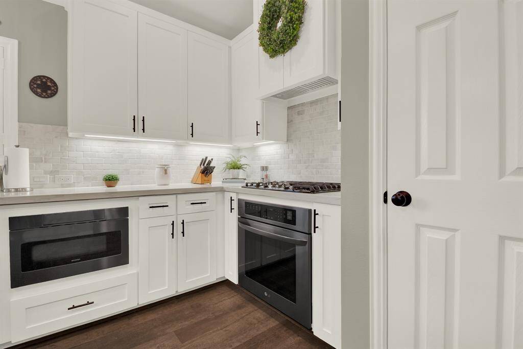 A sleek built-in oven and a gas cooktop.