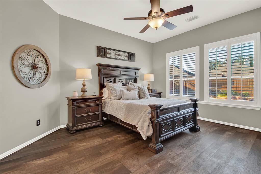 Large, elegant primary bedroom with lots of natural lighting.
