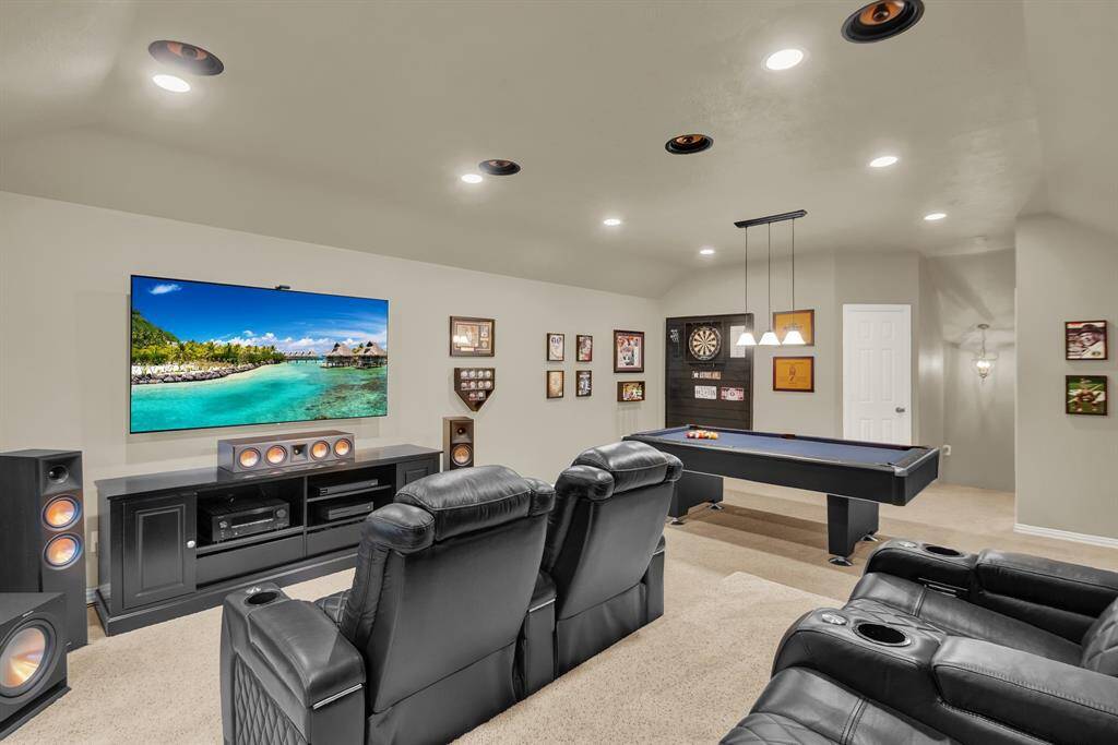 This spacious entertainment room features a space for a large wall-mounted TV.