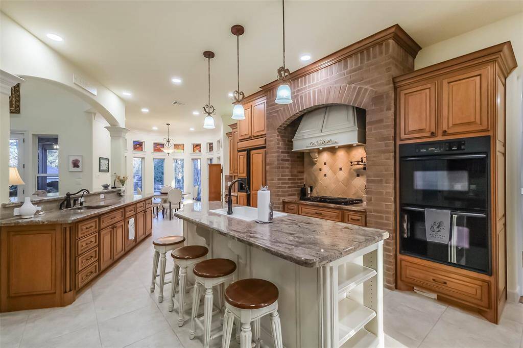 The kitchen is perfectly laid out to prepare for a crowd and features double convection ovens, a gas cooktop, large island, two sinks, reverse osmosis filtration system and TWO PANTRIES!