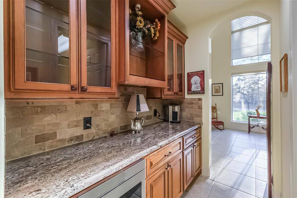 The butler’s pantry has plenty of cabinet space for serving pieces and a stainless steel built-in drawer microwave.