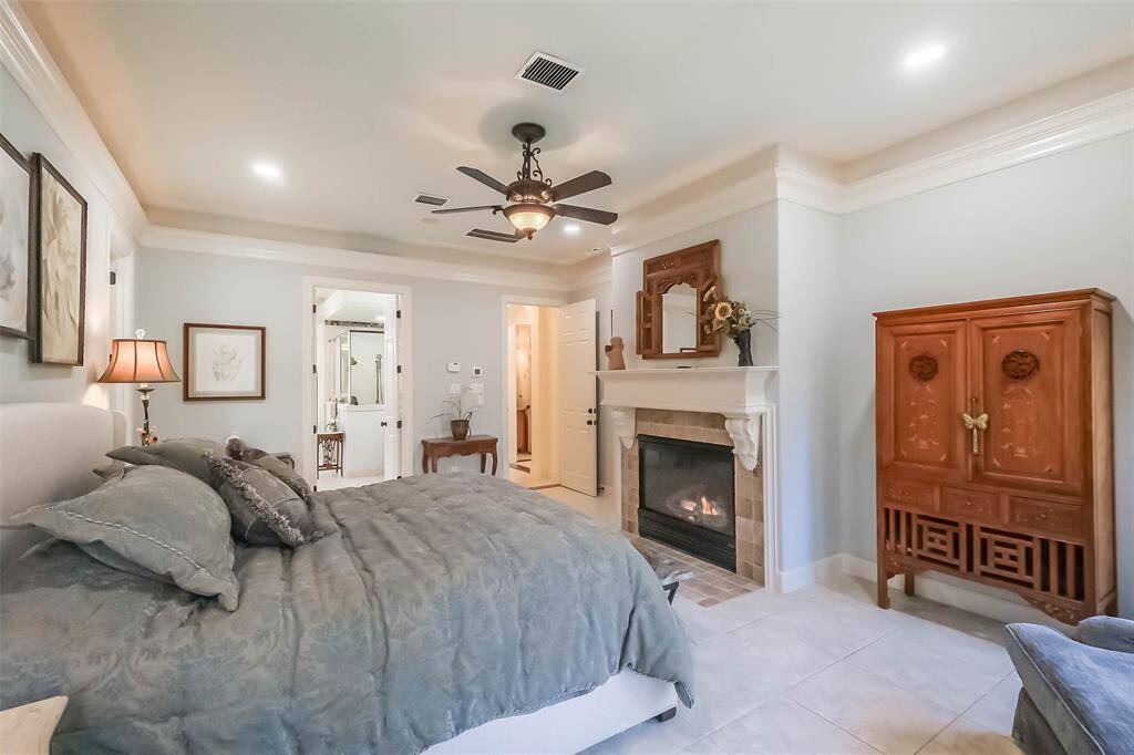 The primary suite features a private fireplace and uplighting and speakers connecting to the whole home audio system.