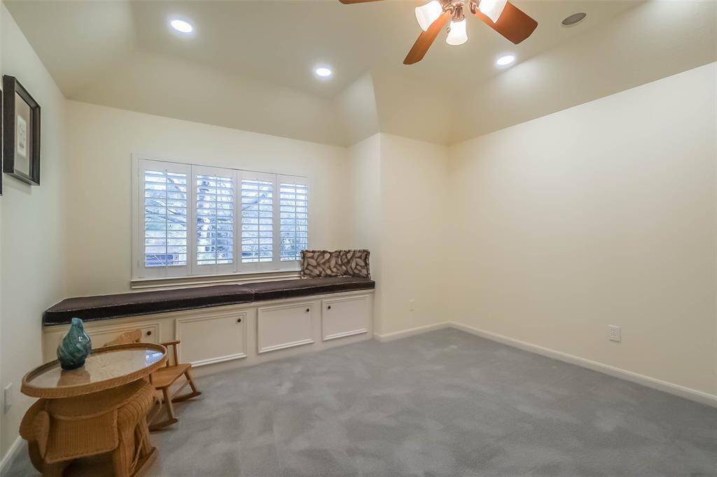 The second of three upstairs secondary bedrooms. This one features a bench seating area with storage.
