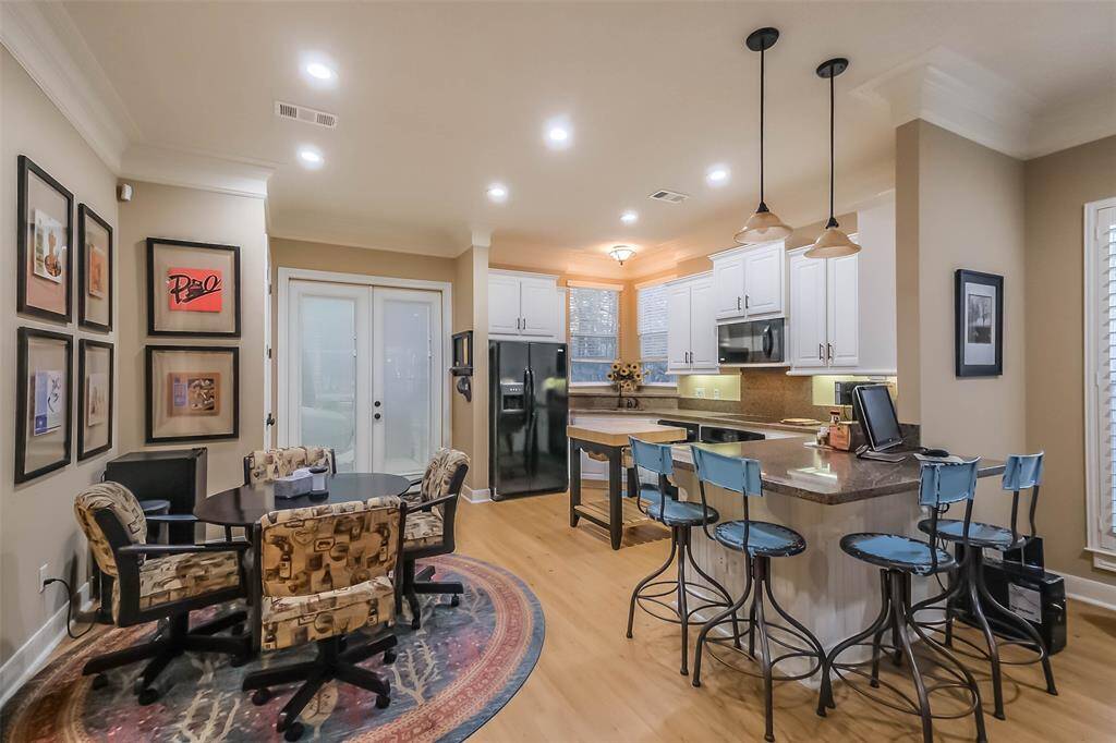 View of the dining area in relation to the kitchen. The double glass doors lead to the garage where the laundry facilities are located.