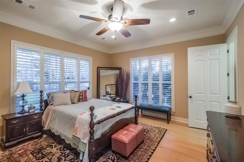 The guest suite bathroom with lots of windows, plantation shutters, a ceiling fan and beautiful crown molding. Your guests may never leave…