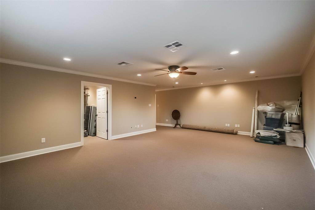 This space, currently used as storage, is a large area above the guest suite in the garage. It has a separate entrance from the guest house and would make a great home office, hobby room or another guest quarters for someone not needing a kitchen. There is a separate bedroom and full bath here as well.