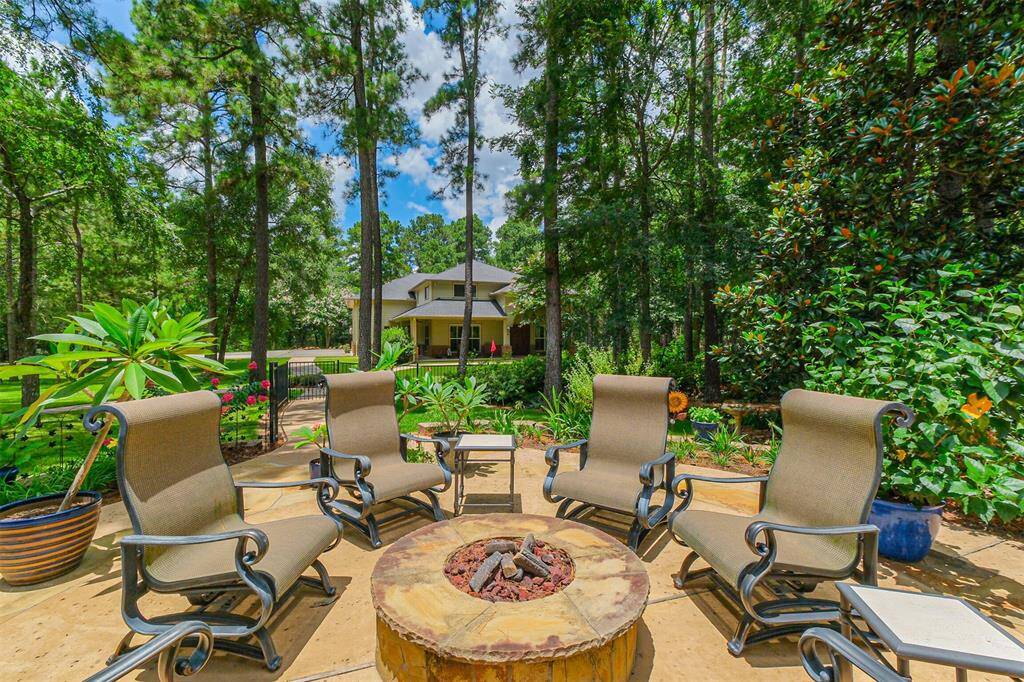 The outdoor firepit is a short distance to the guest suite and surrounded by lush landscaping.