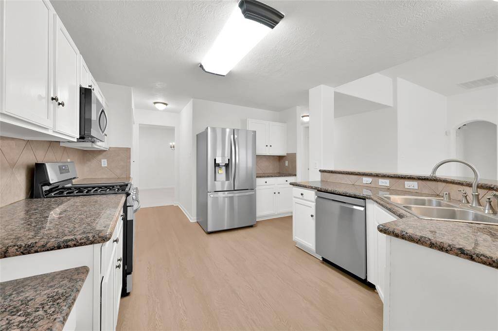 The kitchen has all NEW appliances.  White painted cabinets and granite countertops.