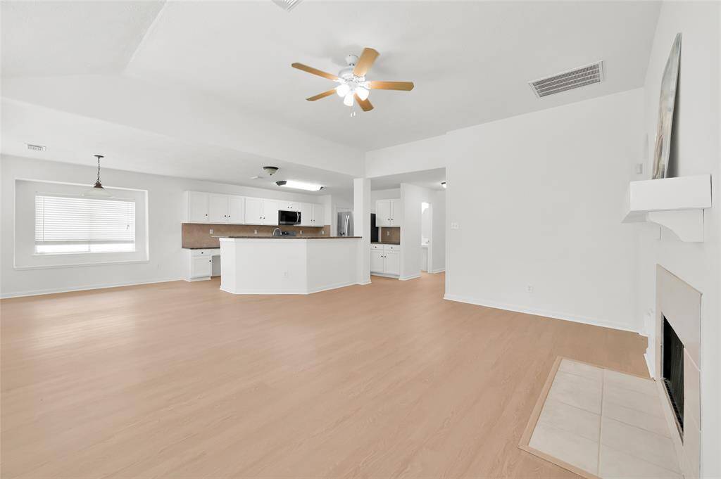 The open layout flows seamlessly into the adjacent kitchen area, creating an inviting space for family gatherings.