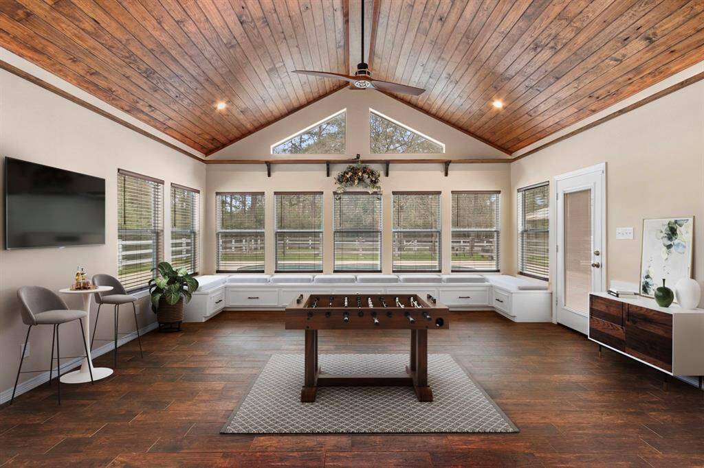 This spacious and inviting additional room features a vaulted wooden ceiling, large windows for natural light, and elegant wood flooring. It’s perfect for relaxation or entertainment, with virtual staging.