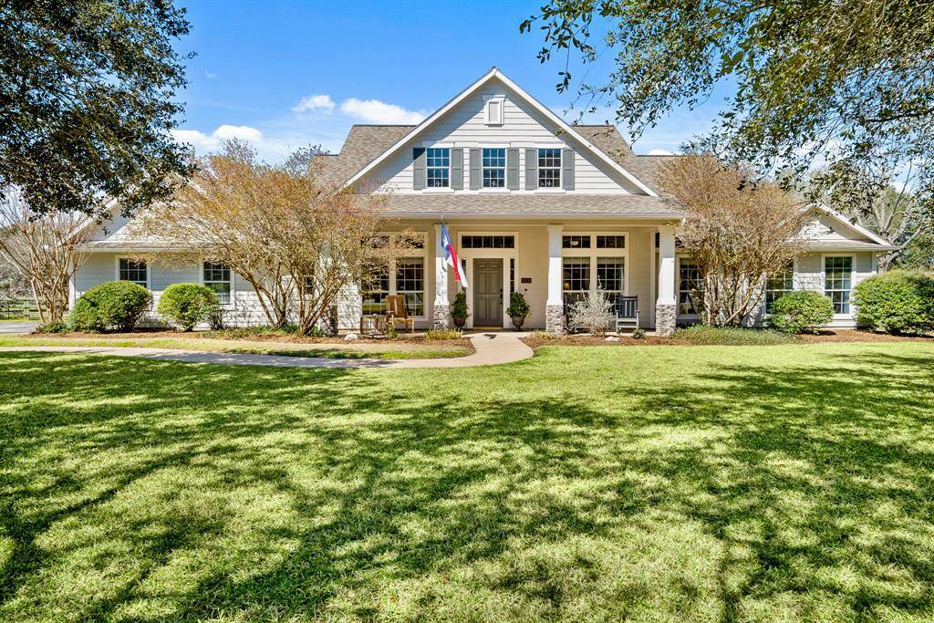 Welcome home! This spacious, country charmer boasts neutral hued siding, stacked stone pillars, and an abundance of curb appeal. Eye catching, yet low maintenance, trees and shrubs line the entire front façade of the home adding dimension and a welcomed pop of color.