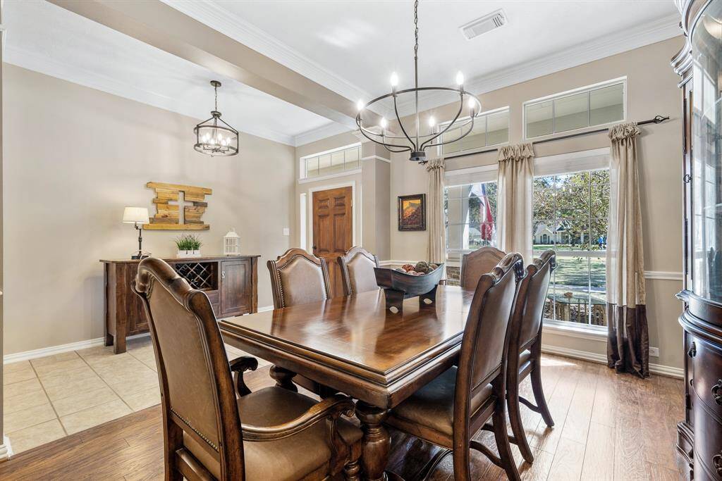 The Dining Room is grand in size and can easily house an 8–10-person table, in addition to a buffet and/or drink cart. Notice how the wrought iron chandelier mimics the one found hanging in the Foyer next door.