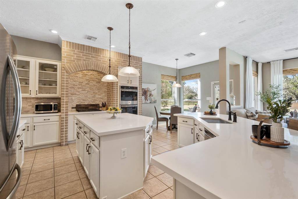 The home chef will feel inspired in this spacious, high-end Kitchen. With so much cabinet and counter space, this Kitchen provides the perfect backdrop for a large potluck dinner or a family cookie decorating competition.