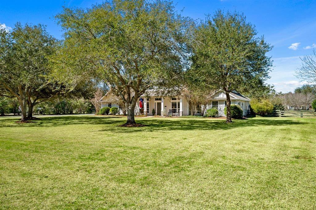 The home is centrally positioned on a sprawling and picturesque one-acre setting. Peace and privacy are enhanced thanks to the home’s depth off the road. Notice how the live oak trees cast dappled shade over much of the Front Yard.
