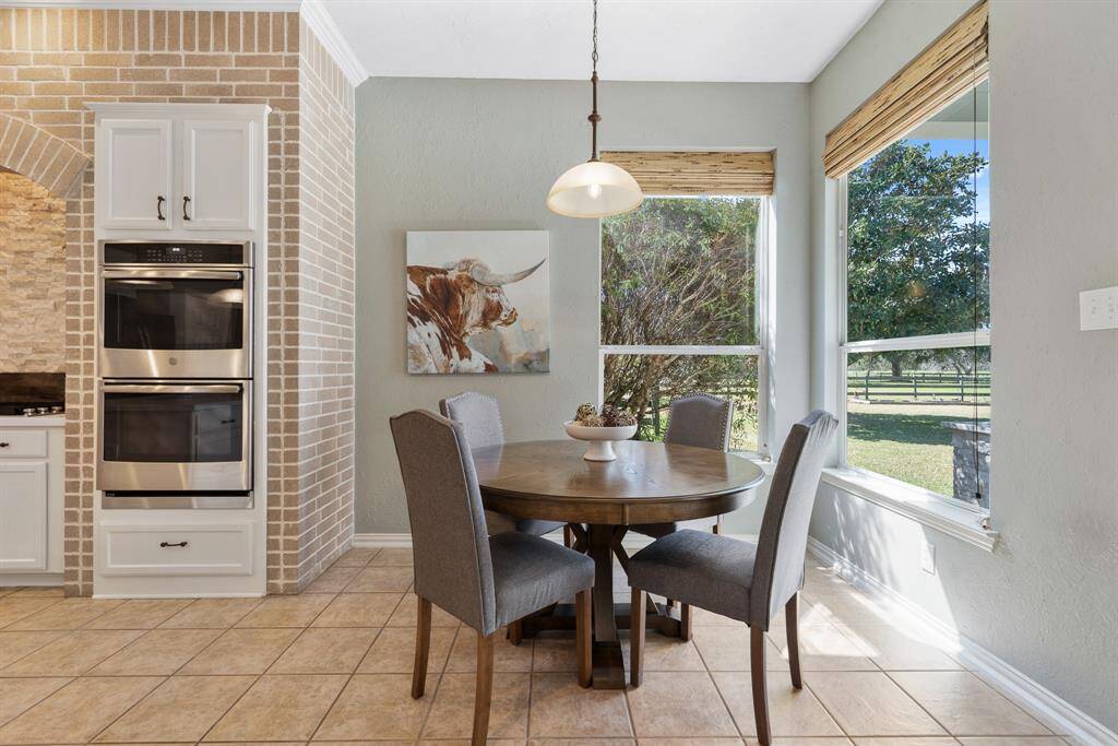 The Breakfast Room dishes up picturesque views overlooking the spacious Backyard pool and lush greenery. Tucked between the Kitchen and Living Room, this space has direct sightlines through much of the main living space.