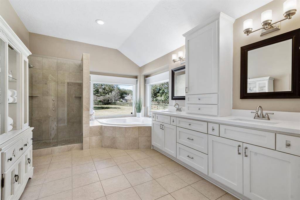 Equipped with two undermount sinks, quartz countertops, and an abundance of open and closed storage, this Primary Bathroom is sure to suit all your needs. Unique to this home is a spacious closet that is accessible from both the Bedroom and Bathroom.