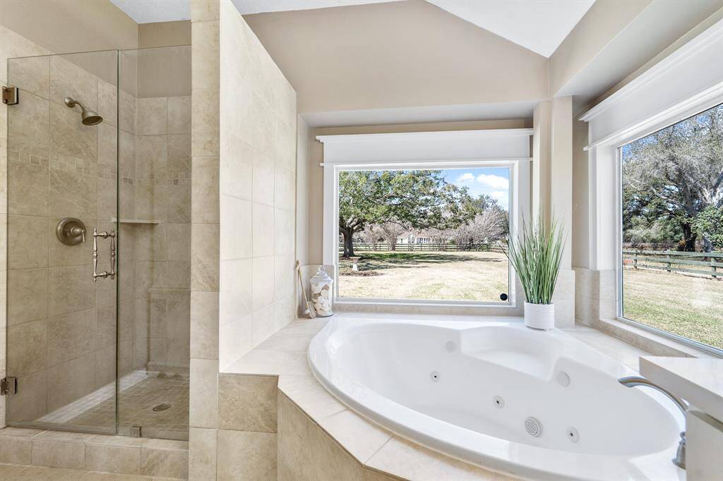 Let the stress of the day wash away in this grand shower with frameless entry and tile surround. Two picture windows frame this oversized soaker tub, providing a five-star view every hour of the day.