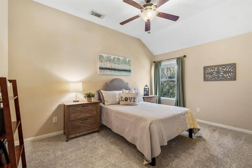 This Secondary Bedroom, located directly off the Game Room, boasts wall-to-wall plush carpeting, a side-facing window, and walk-in closet. The two Secondary Bedrooms share the spacious Bathroom located down the hall.
