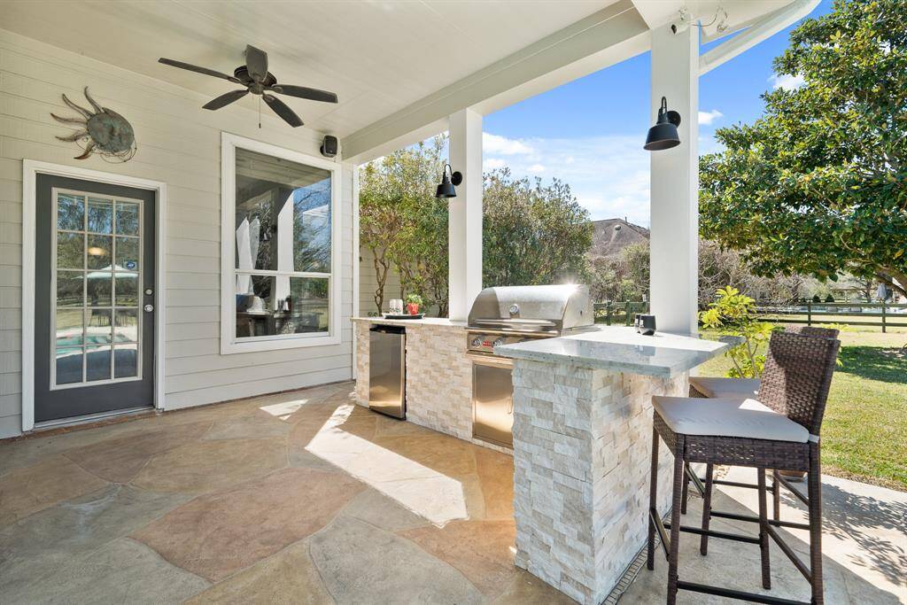 The Summer Kitchen comes equipped with a built-in 4-burner grill, fridge, and granite countertop. Two lights and a ceiling fan keep this space useable and comfortable year-round. The space also boasts outdoor speakers, making this the perfect place to entertain.