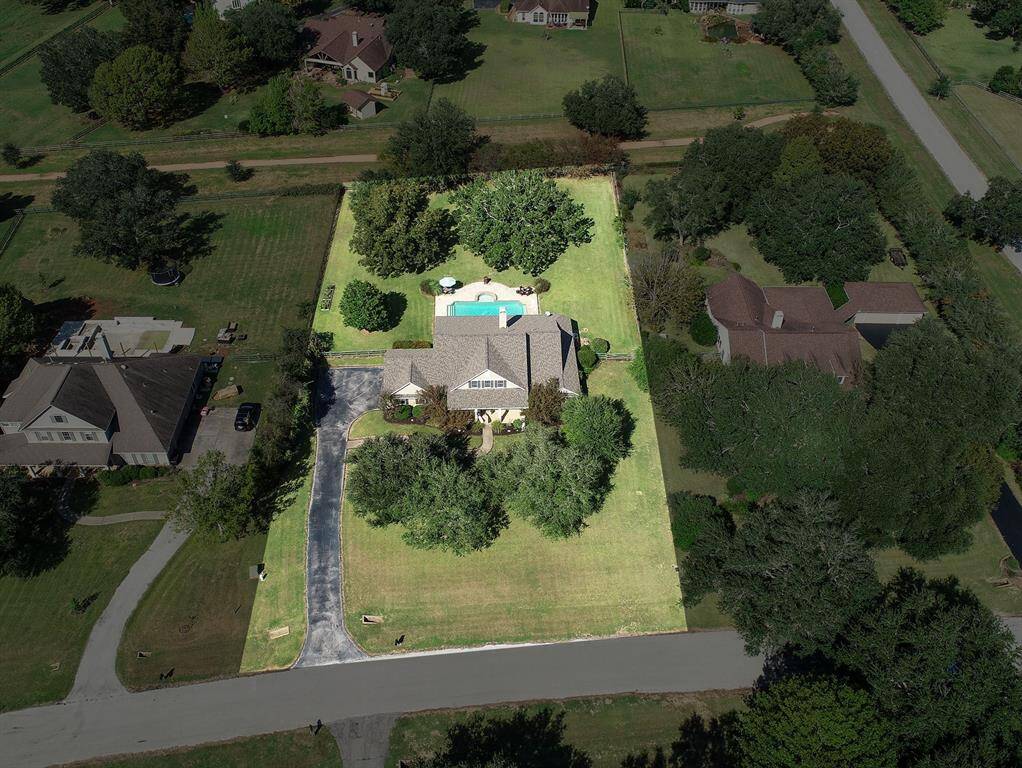 This bird’s eye view is needed to truly appreciate this tranquil property. Notice how both the Front Yard and Backyard are shaded year-round thanks to the abundance of mature trees. Paths traverse the neighborhood, as seen on the other side of the fence line, providing a safe place to ride bikes and walk the dog.