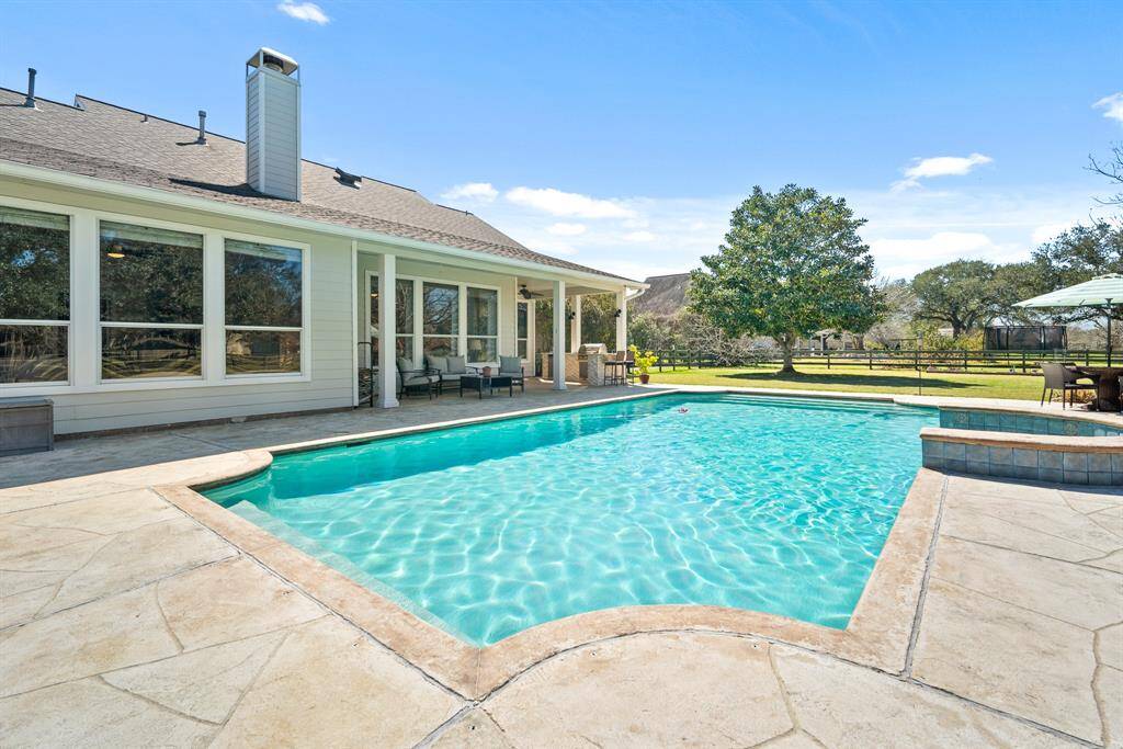 The Pool boasts a tanning ledge, a gradual entrance, and a max depth of  6 ft. The stamped concrete pool deck provides a cool and slip-free surface for those meandering to and from the outdoor fridge looking for a refreshing drink.
