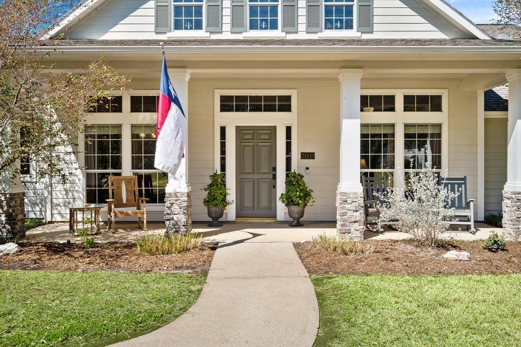 Guests will meander the front walkway and approach this stately, solid wood front door with sidelights and transom above. Adding a pair of pots on either side of the door adds another sweet dose of southern charm and style.