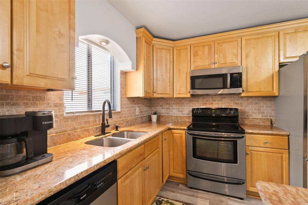 Stainless steel appliances and ample storage in the kitchen.