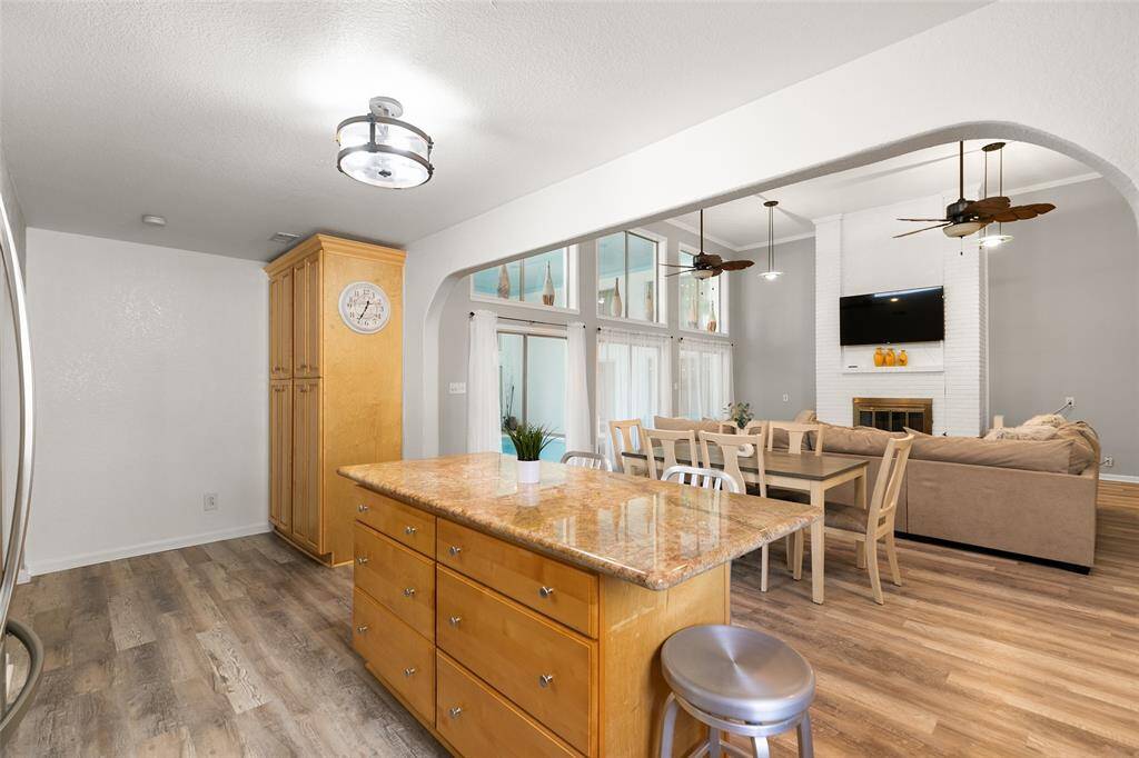 Island kitchen opens to dining area and living room.