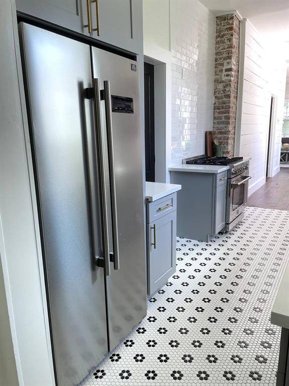 The kitchen has a door leading to the second bedroom.