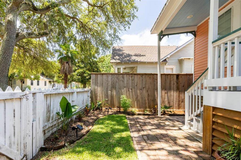 Enjoy the gated courtyard with brick pavers.