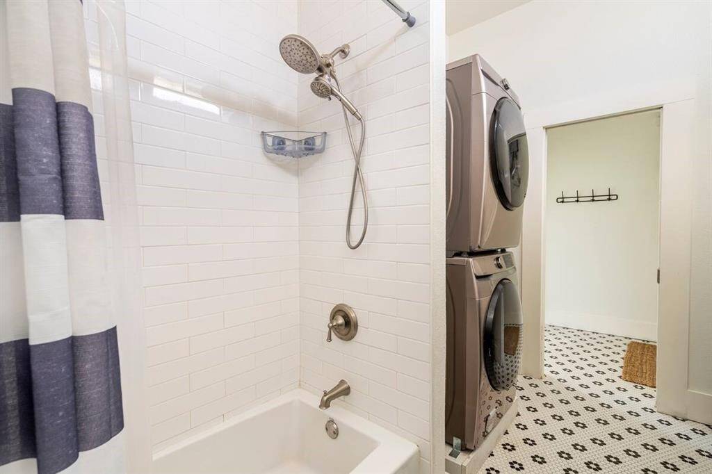 The bathroom is spacious and includes the washer/dryer.