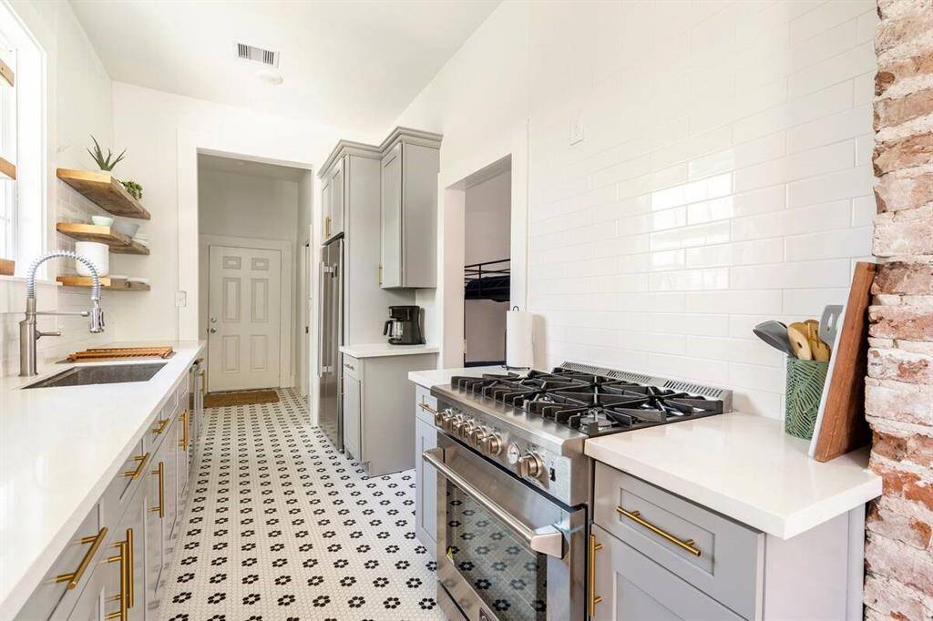 The kitchen is incredibly stylish with high end appliances and features original exposed brick.