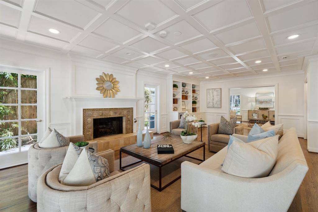 This is the southeast perspective of the den/library [26' x 17']. The French doors on either side of the mantle lead to the spectacular side garden and paved walkway. This lushly landscaped courtyard is reminiscent of Charleston-style mansions.