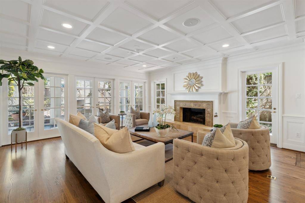 This wide-angle photo provides a superb vista of the generously sized room. The north wall of French windows overlook the secluded study. The abundance of natural light makes this room a favorite space for all guests.