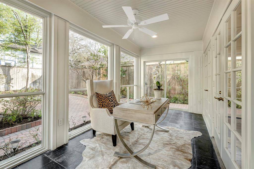 The downstairs study [14' x 7'] is a secluded and enclosed room.  The floor-to-ceiling windows consist of expansive glass panels without panes to optimize natural light. Historically a screened in space, this room could be coverted to a backyard loggia.