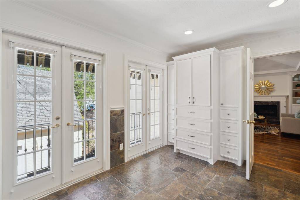 One wall features a cleverly designed built-in wardrobe, similar to an armoire. The two separate primary bathrooms both have privacy doors to the primary bedroom and lounge. Both spaces are filled by natural light and include new* LED ceiling lights. *January 2025 per Seller