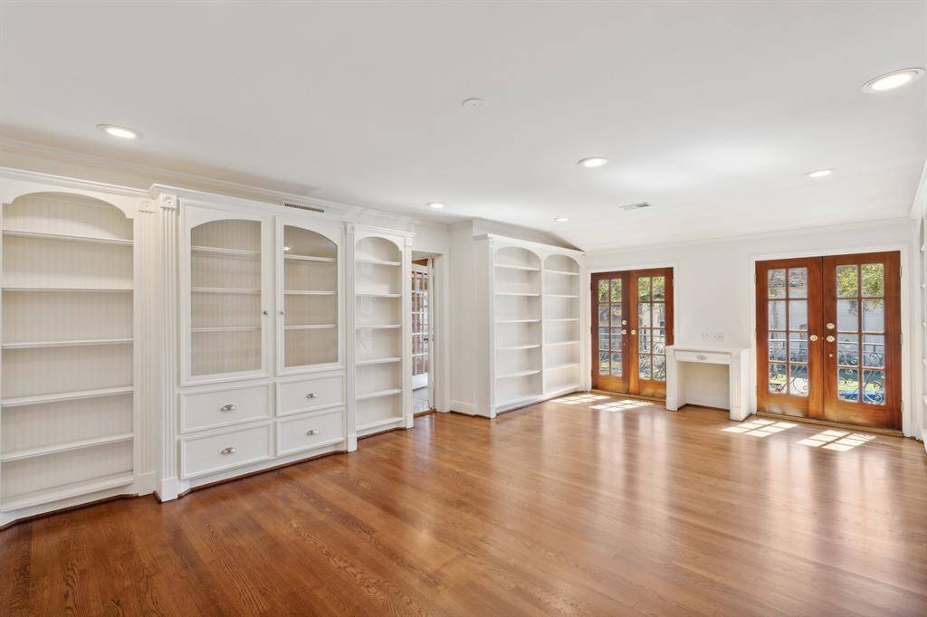 Step into the oversized second bedroom upstairs [22' x 14'], which includes two sets of deluxe double-pane mahogany French doors. These doors were added in 2006*. "Juliet" balconies were added when the original sleeping porch was reconfigured to add extra square footage to several rooms. The contiguous arched built-in bookshelves provide visual interest and have previously accommodated books and collectibles.