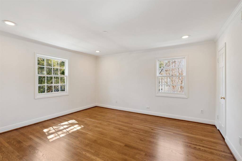 The third bedroom [14' x 13'] is situated on the southwest corner upstairs. This room has two windows with tree-top views and connects to the Hollywood bathroom and fourth bedroom (behind the far right door). The oak hardwood floors upstairs have just been newly* sanded, stained and refinished. *February 2025 per Seller.